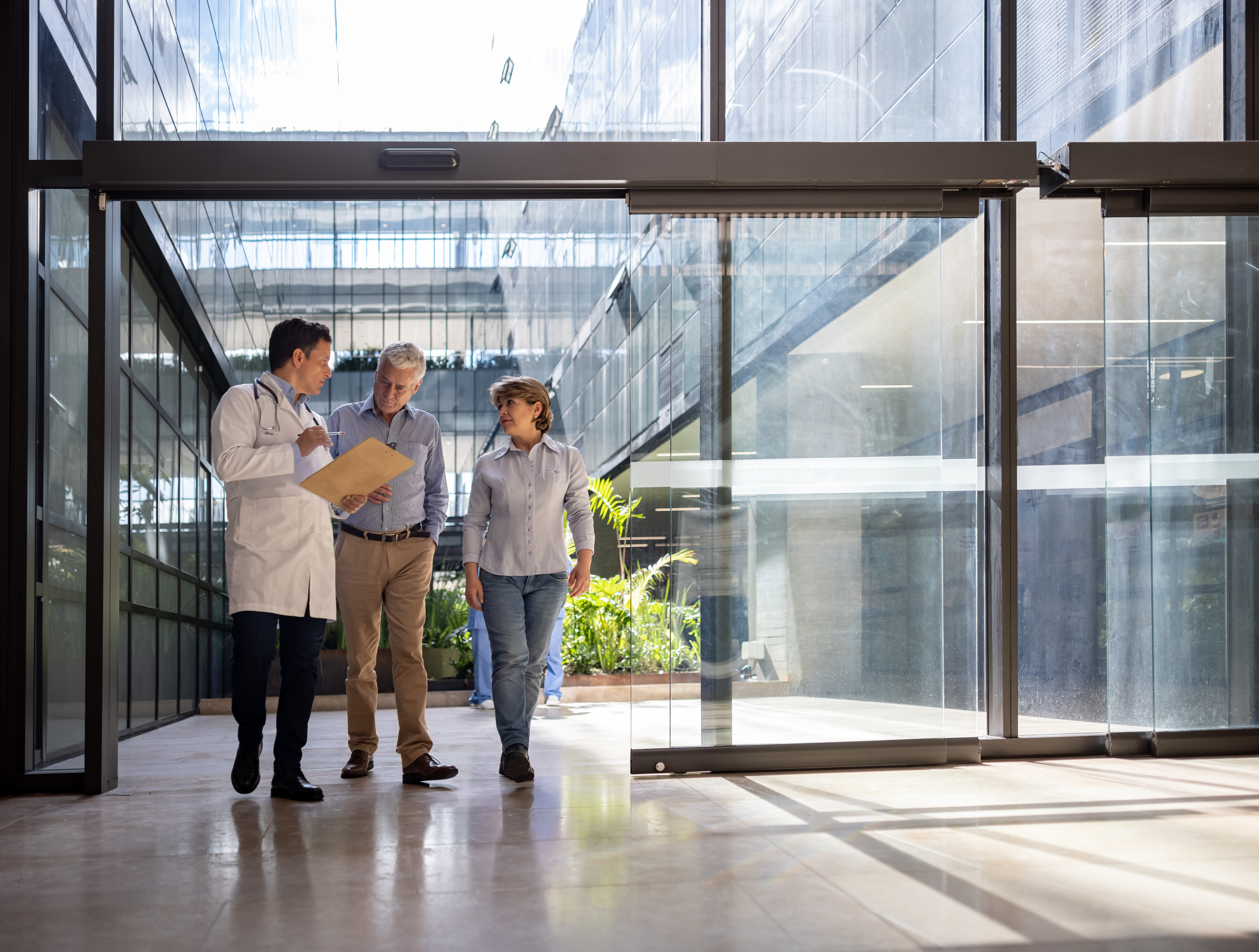 Doctor consulting international patients in a modern Bogota medical clinic for various treatments.